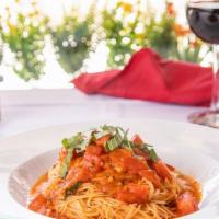Capellini Pomodoro · Angel hair pasta sautéed with fresh tomato, roasted garlic, basil, and olive oil