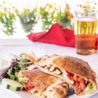 Chicken Pesto Calzone · Roasted chicken, house made pesto sauce, mozzarella cheese, chopped tomato, and roasted red ...
