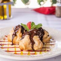Crème puff bigne · pastry puffs, filled filled with custard cream, and chocolate fondant drizzle.