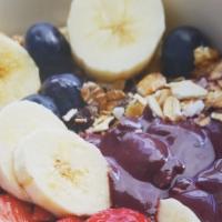 Acai Berry Bowl · Acai berry blend topped with granola mix, banana slices, strawberry slices, and blueberries.