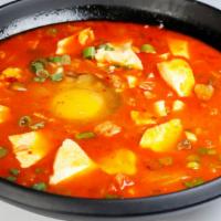 S02. Kimchi Soft Tofu Soup · Spicy tofu soup with pork belly, spicy Korean cabbage, enoki mushroom and top with an egg.