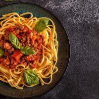 Spaghetti with Meat Sauce · Homemade spaghetti, fresh garlic, basil, and meat sauce.