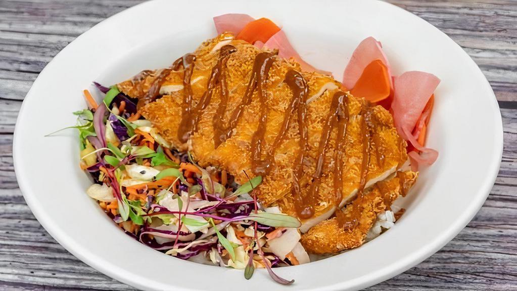 Chicken Katsu Rice Bowl · Chicken breast breaded with our house spice blend and panko then fried to perfection. Served over chicken rice with sesame slaw, fukujinzuke, and our house-made tonkatsu sauce.