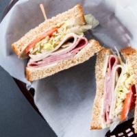 Café Club · Thin-sliced turkey and ham with bacon, cheddar, lettuce, and tomatoes.