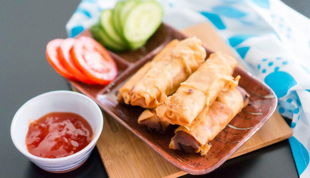 Egg Rolls with Cucumber Slices 素炸春卷伴青瓜 · Crispy dough filled with minced vegetables.