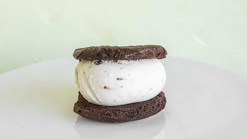 Vegan Ice Cream Sandwich · Two Vegan cookies with a scoop of non-dairy ice cream.