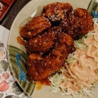 Fried chicken wings with sweet & hot sauce · Mild spicy.
