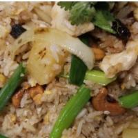 Pineapple Fried Rice · Fried rice with pineapple, cashews, & scallions raisins garnished with cilantro.