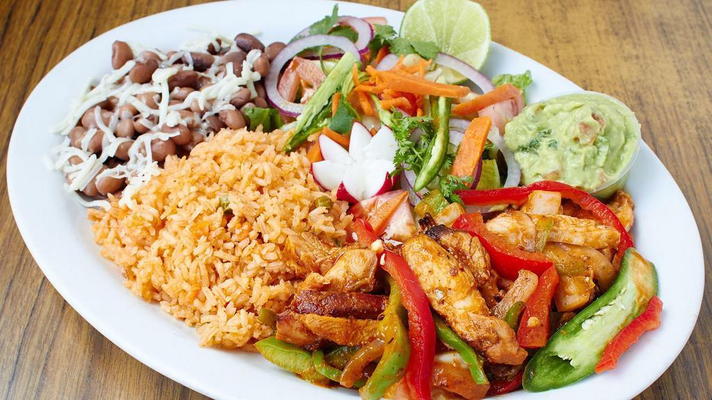 Spicy Chicken Dinner · Spicy chicken with red sauce, rice, beans, salad and tortillas.