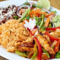 Plancha Grilled Salmon · Salmon a la plancha with rice, beans, avocado salad and tortillas.