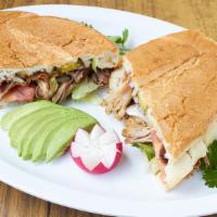 Torta Ahogada Sandwich · Smothered in a special Jalisco hot sauce and onions.