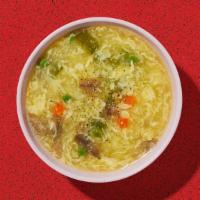 Egg Drop Soup · Wispy beaten eggs in a flavorful chicken broth with peas and carrots.