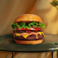 Vegan Classic Burger · Seasoned 1/3 lb. Impossible meat patty topped with lettuce, tomato, onion, and pickles. Serv...