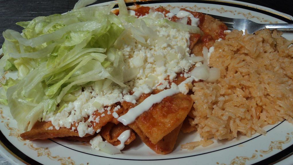 Chilaquiles · Crispy tortilla strips cooked in green, red or pasilla sauce topped with onion, cheese and sour cream.
