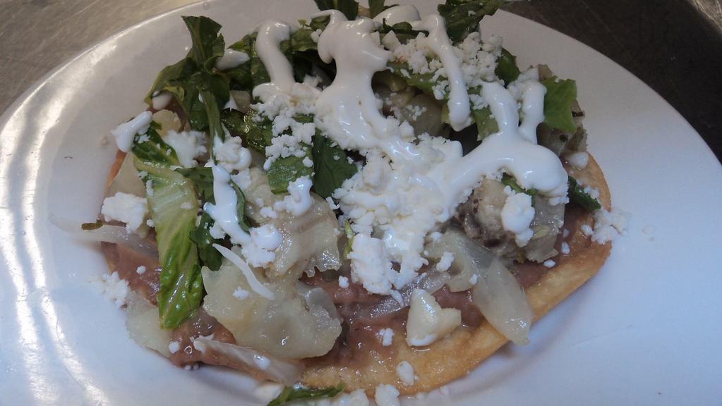 Tostadas · Served with beans, Mexican cheese, lettuce and your choice of beef feet, chicken and tinga (mix of onion, chicken and chipotle).
