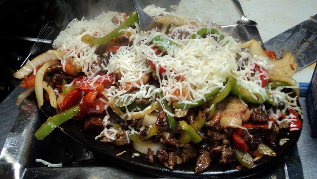 Alambre Combination Fajita · Grilled bell pepper, onion, bacon and chorizo, topped with cheese and a combination of beef, chicken, pork and shrimp.