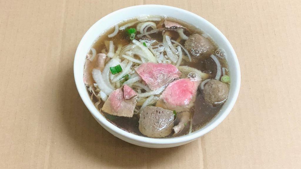 1. X-Large Combo with meat ball/ Phở Xe lửa Bò Viên · With rare slice of steak, well done brisket and flank, tendon, tripe and meat ball.