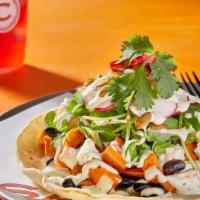 Sweet Potato & Black Bean Taco · Roasted and sautéed with whole black beans, and topped with pea shoots, radishes,  artisan g...