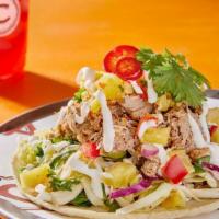 Carnitas Taco · Iowa raised, all natural and hormone free, our pork is slow roasted all day with cinnamon, r...