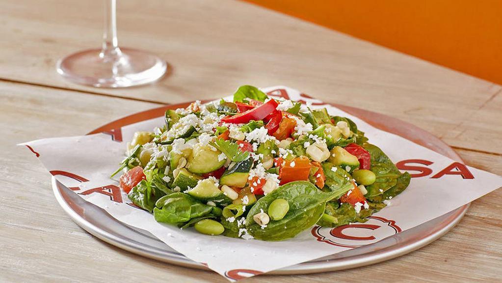 Vegan Power Green, Grilled Corn, Red Pepper and Edamame Salad · Power greens tossed in a lemon vinaigrette with grilled corn salsa, zucchini, red bell pepper, edamame, scallions, serrano chile, garlic, vegan parmesan cheese, Fresno peppers and finished with cilantro and fleur de sel.