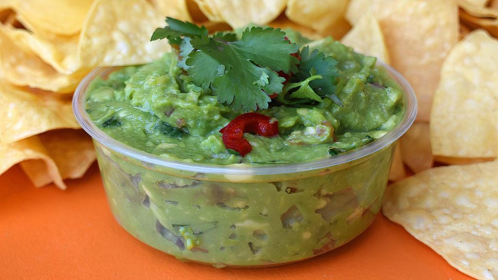 Housemade Guacamole · Our signature guacamole made with Roma tomatoes, serrano chile, red onion, garlic, cilantro and lime juice.  Topped with artisan cotija cheese and cilantro.