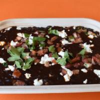 C CASA Black Beans · Slow cooked and made with chorizo and artisan goat cheese. Finished with pico de gallo, arti...