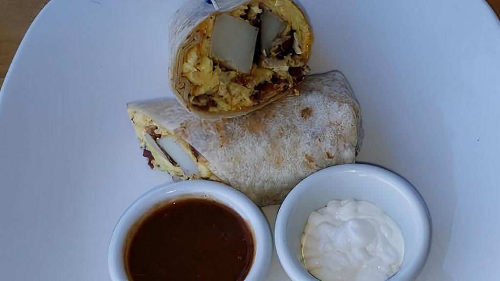 Breakfast Burrito  · Two Eggs, Bacon, Ham, Chorizo or Sausage, Hash brown and cheddar cheese