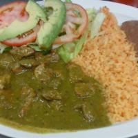 CHILE VERDE · Pork cooked in chile verde sauce; served with rice, refried beans, small salad, and flour or...