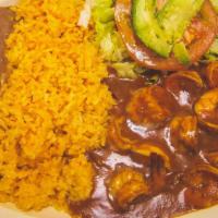 CAMARONES A LA DIABLA · Shrimp in spicy hot sauce; served with Spanish rice, refried beans, a small salad, and handm...