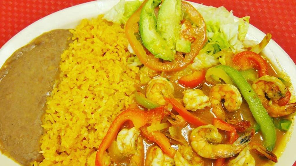 CAMARONES RANCHEROS · Shrimp cooked with onions, bell peppers, and special sauce; served with rice and small salad.