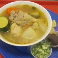 CALDO DE POLLO · Chicken soup cooked with carrots, potatoes, and zucchini; served with lime slices, a side of...