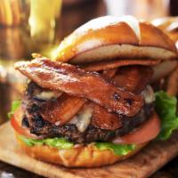 Bacon Cheeseburger · Juicy beef patty with melted cheese, bacon, fresh lettuce, tomato, and red onions on a bun.