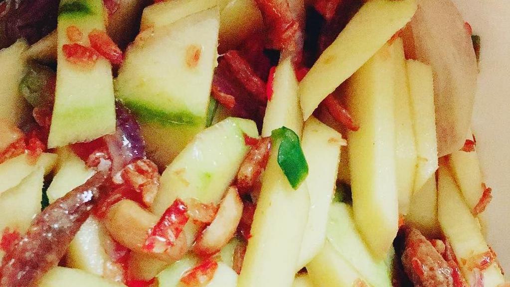 Yum Pla Muek · Calamari, ginger, yellow onion, green onion, sweet chili paste, tomato, and mint. Served with a mixed green salad.