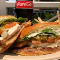 Torta Suprema · Choice of meat, refried beans, lettuce, tomato, onion, avocado slices, queso fresco and sour...