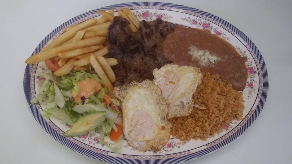 Steak and Eggs / Steak y Huevos · A Steak with two eggs and a side of rice and beans. 
Steak con dos huevos, arroz y frijoles am lado.