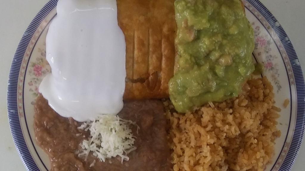 Chimichanga · Your choice of meat inside a fried flour tortilla , topped with sour cream and guacamole .Served with rice & beans.