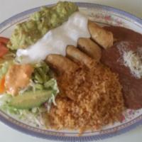 Flautas · 4 crispy chicken flautas toped with sour cream and guacamole . includes rice and beans.