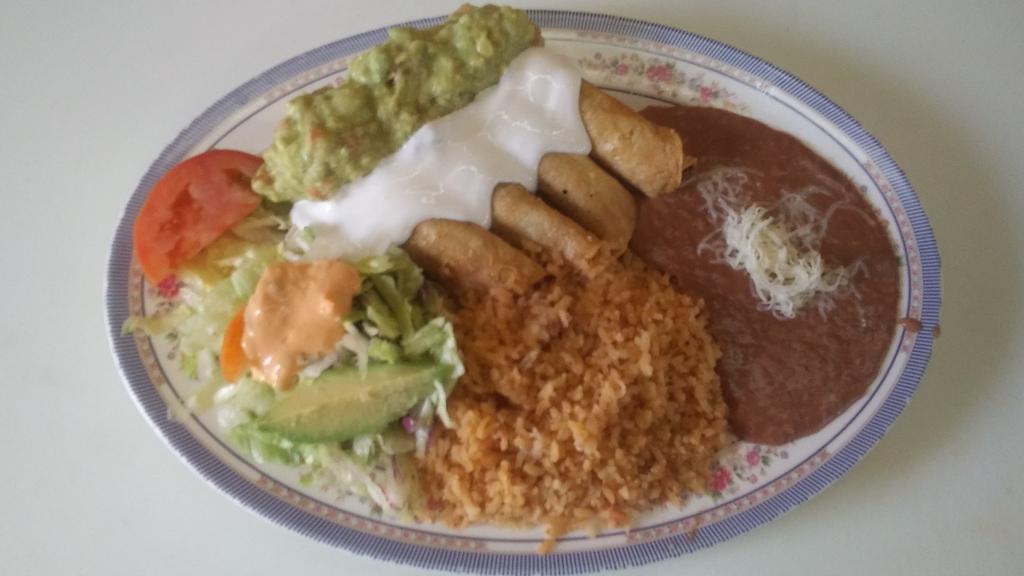 Flautas · 4 crispy chicken flautas toped with sour cream and guacamole . includes rice and beans.