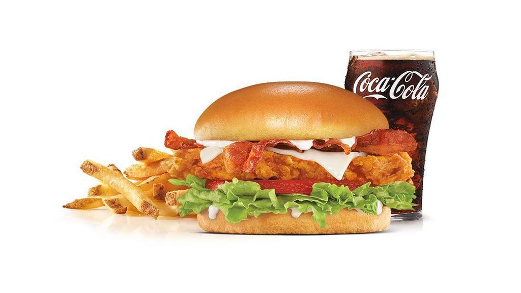 Hand-Breaded Bacon Swiss Chicken Sandwich Combo · Premium, all-white chicken fillet, hand dipped in buttermilk, lightly breaded and fried to a golden brown, topped with bacon, Swiss cheese, lettuce, tomato, and mayonnaise on a potato bun. Served with Fries and a Beverage.