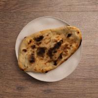 Garlic Naan · Oven-baked flatbread topped with garlic.