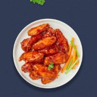 Blazing Buffalo Wings · Fresh chicken wings breaded, fried until golden brown, and tossed in buffalo sauce. Served w...