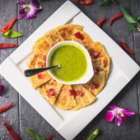 Roti with green curry · Pan-fried roti (asian pita bread) served with green curry dipping sauce, garnished with dice...