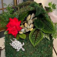 Living Purse · An assortment of succulents, plants and mini orchids in a moss covered purse. Stand not incl...