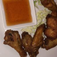 Chicken Wings · Fried chicken wings with a chipotle sweet and sour dipping sauce. Make it spicy at an upchar...