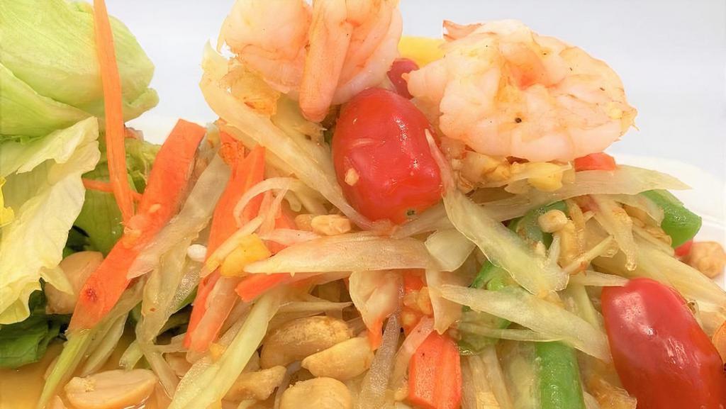Som Tum · Shredded green papaya with shrimps, tomato, chilies, green beans, peanuts tossed with lime based salad dressing