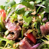 Beef Salad (Yum Nur) · Roasted beef tossed with onion, chili, cucumber, tomato in chili lime dressing