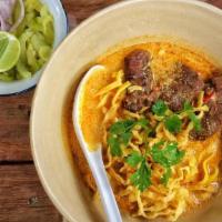 Kao Soy Curry · Egg noodle topped with special yellow curry with onion, carrot, pickles and crispy noodle