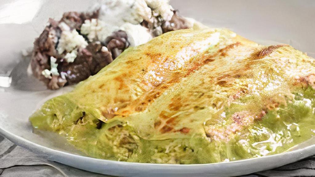 8. Enchiladas Suizas · 3 enchiladas Slow roasted green sauce chicken enchiladas served with rice and Beans.