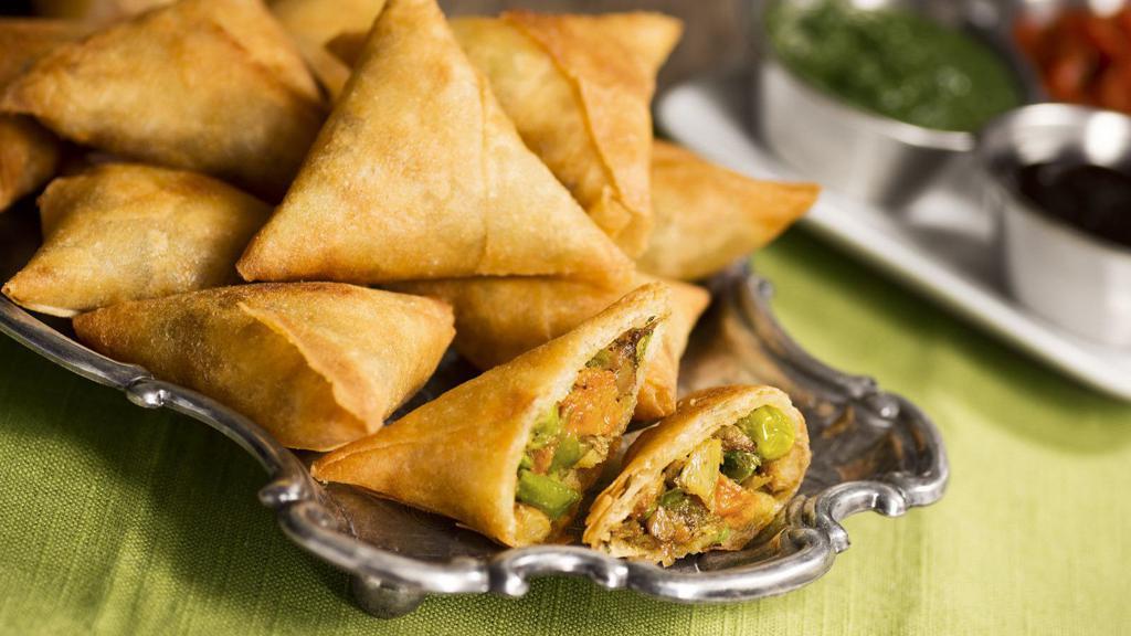 Veggie Samosa · Delicious pastry stuffed with peas and potato. Comes with tamarind sauce.