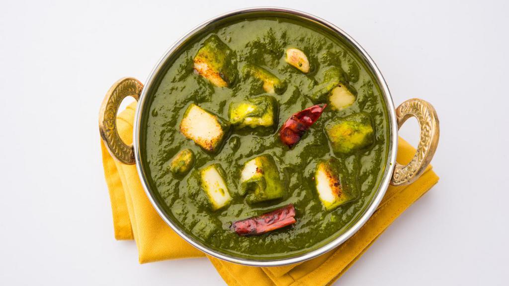 Palak Paneer · Creamed spinach cooked with fresh cottage cheese and Indian spices. Served with white basmati rice.